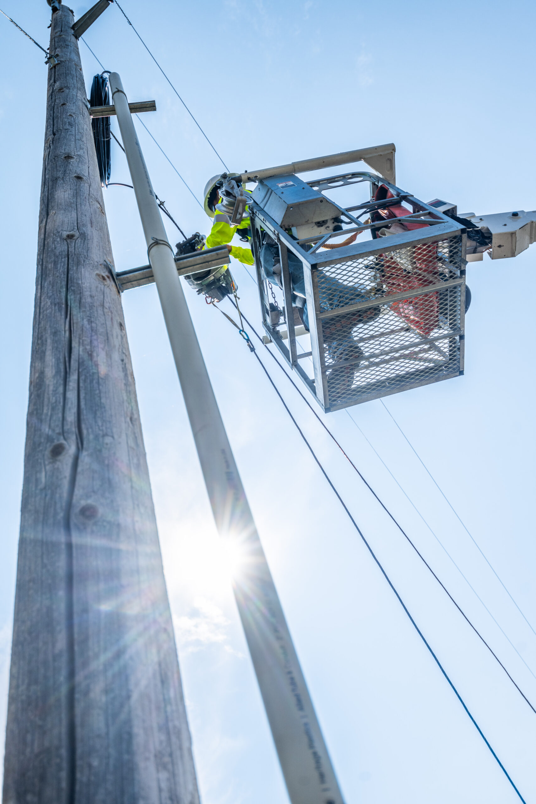A Valhalla Industries telecommunications lineman installing fiber optic cable